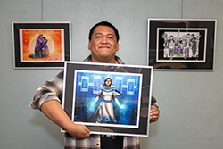 An artist holds his work.