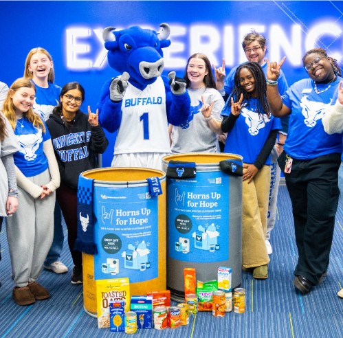 Students in Buffalo t-shirts smile and surround Buffalo mascot.