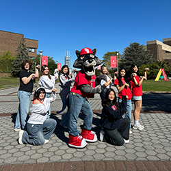 Students pose around Wolfie mascot.